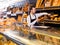 Male shop assistant demonstrating delicious loaves of bread in bakery