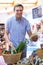 Male Shopper In Delicatessen Buying Organic Produce