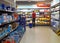 Male shopper perusing the grocery store aisles, examining the products on the shelves in Katwijk