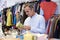 Male Shopper In Thrift Store Looking At Ornaments