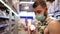 A male shopper wearing a medical protective mask selects groceries