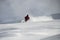 Male on a ski gliding on a snowy mountain