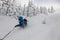 Male skier curved and brakes spraying loose deep snow on the freeride slope. Freeride, winter sports outdoor