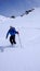 Male skier and fresh tracks in untouched powder snow in the backcountry of the Swiss Alps