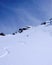 Male skier and fresh tracks in untouched powder snow in the backcountry of the Swiss Alps