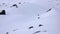 Male skier and fresh tracks in untouched powder snow in the backcountry of the Swiss Alps