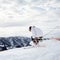 Male skier skiing downhill trough deep snow in mountains.