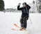 Male skier sliding down snow-covered slopes on skis.