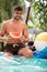 Male with slice of watermelon on pool