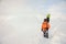 Male snowboard rider standing on the background of mountains