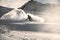 Male snowboarder with face covered in snow slipping on snowy mountain