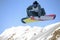 Male snowboarder jumping with snowboard