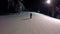 Male snowboarder slides down from the mountain in winter night. the guy on the snowboard is sliding from the mountain in