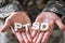 Male Soldier Holding Wooden Cubes With PTSD Text