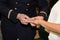 Male soldier putting engagement ring on girlfriends finger wedding bride groom marriage