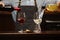 Male sommelier pouring red and white wine into long-stemmed wineglasses