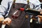 Male sommelier pouring red wine into long-stemmed wineglasses.