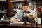 Male sommelier tasting red wine and making notes at bar counter