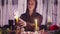 Male sorceress psychic lights a candle for rituals