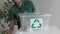 male sorting out plastic home waste in recycling container indoors