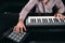 Male sound producer hands on musical keyboard