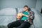 Male spectator sleeping on sofa in cinema hall