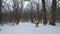 Male sports man warming up during snowfall in winter forest with free space