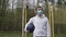 Male sportsman basketball player with a ball in a mask in a closed playground alone in quarantine during the pandemic