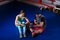 Male sporty boxer preparing bandages sitting near athletic female