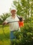 Male spraying tree branches