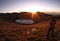 A male standing on a higher place by the Jiaming lake , and waiting for the beautiful sunrise. Ready to take some photos.