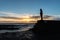 Male standing by Stonehaven harbor at sunrise