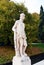 Male statue, river, trees and street in Castelfranco Veneto, in Italy