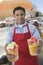 Male Street Vendor Holding Fresh Fruit Salads