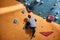 Male student climbing at artificial wall, spending free time in bouldering gym