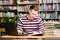 Male student with laptop studying in the university library