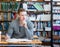 Male student with open book working in a library