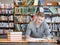 Male student with open book working in a library