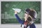 Male student playing a paper plane