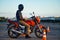 Male student poses on motorbike, motorcycle school