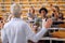 Male student raising the hand to answer the professor question at the lecture