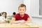 Male student sitting at desk with folded arms during lesson