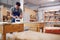 Male Student Studying For Carpentry Apprenticeship At College Using Wood Plane