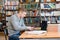 Male student using smartphone in the university library