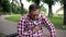 Male suffering sudden chest pain, sitting on bench in park, cardiology, health