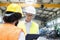 Male supervisor discussing with manual worker in metal industry