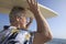 Male surfer carrying surfboard at ocean