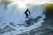 Male surfer enjoying the big wave in Oceanside