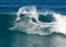 A male surfer executing a backside top-turn off-the-lip at Iluka`s North Wall.