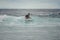 Male surfer riding on a surfboard on a wave